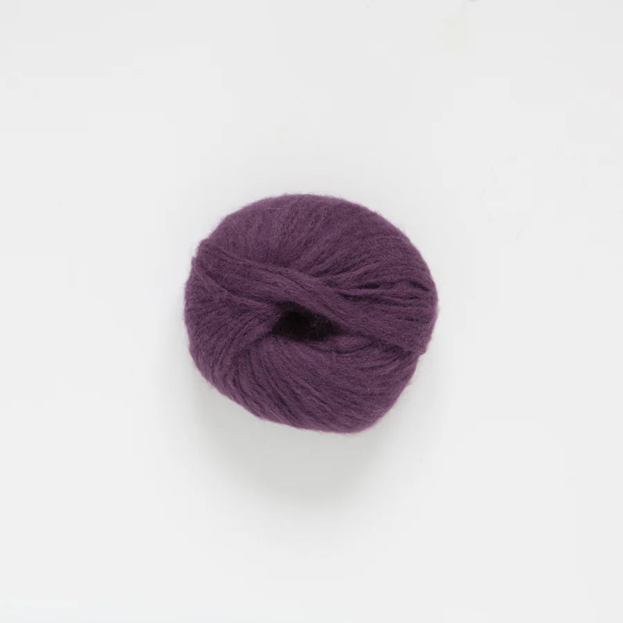 Purple alpaca yarn ball on a white background
