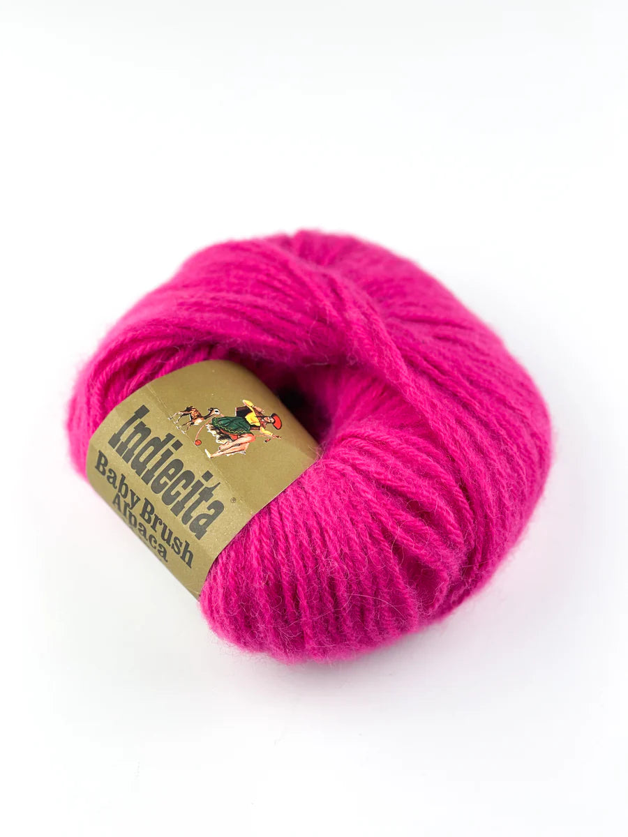 Pink skein of alpaca yarn with a label on a white background