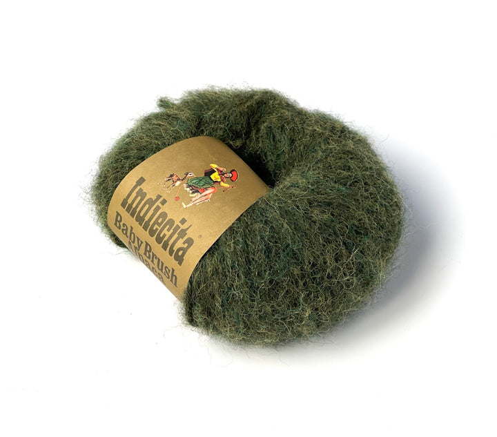 Green ball of alpaca yarn with a label on a white background