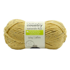 A skein of Cleckheaton Country Naturals 8 Ply yarn in beige color with tweed patterns, labeled as 50g and 96m.