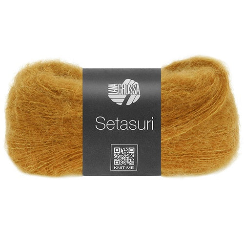 Ball of gold yarn with a label on a white background