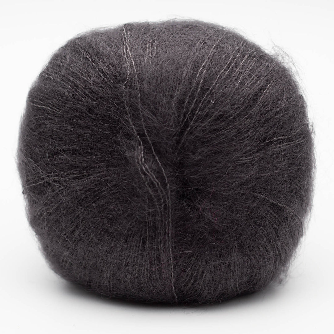 Ball of dark gray Silky Kid yarn in the shade anthracite on a white background