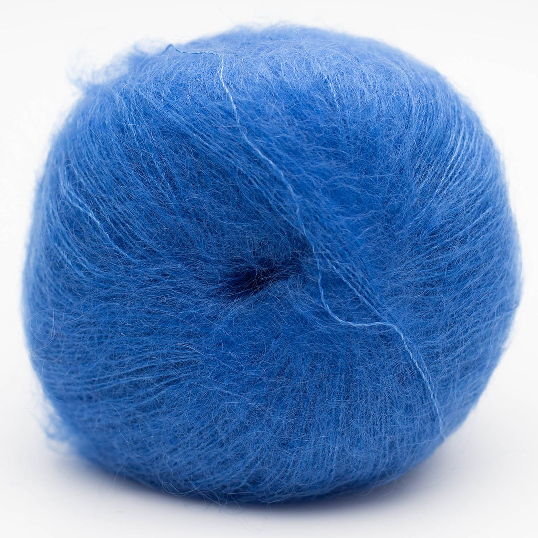 Blue skein of Silky Kid yarn on a white background