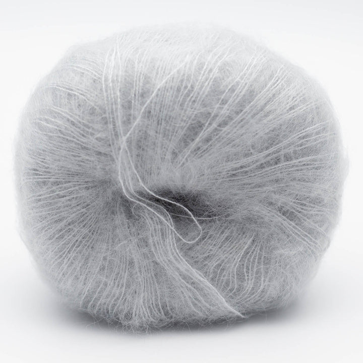 Ball of light gray Silky Kid yarn in the shade fog on a white background