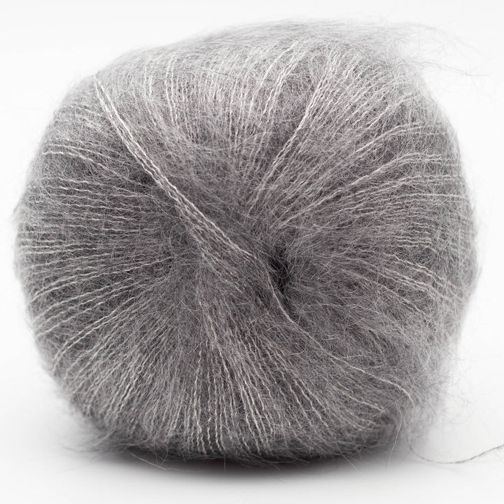Gray skein of Silky Kid yarn on a white background
