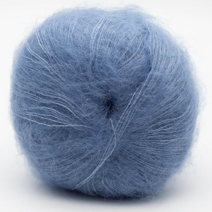 Ball of blue Silky Kid yarn on a white background