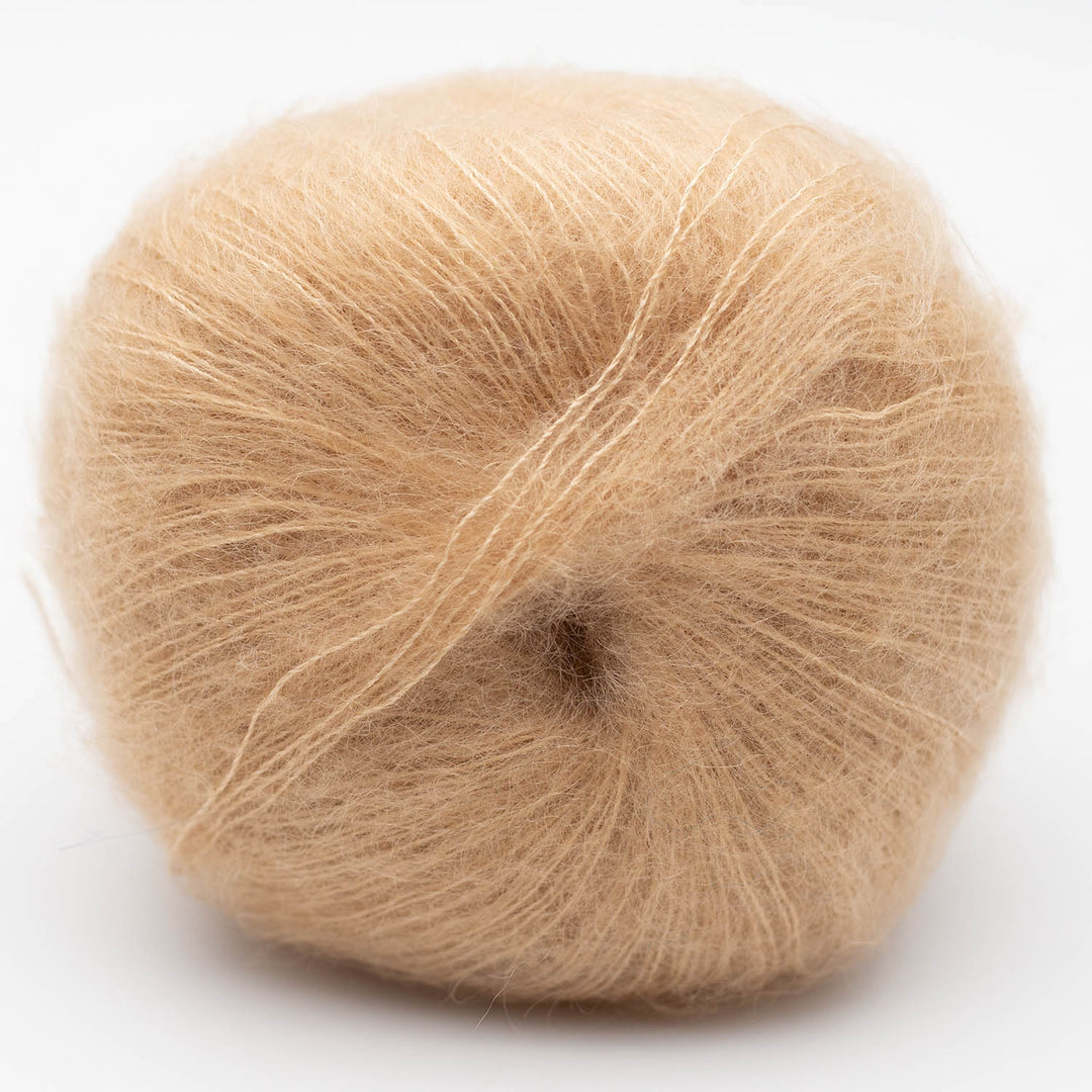 Ball of beige Silky Kid yarn on a white background at The Wool hop