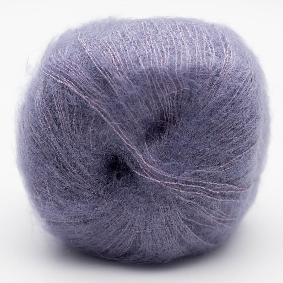 Ball of muted purple Silky Kid yarn on a white background