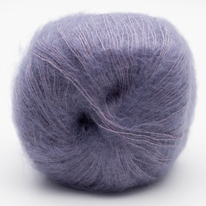 Ball of muted purple Silky Kid yarn on a white background