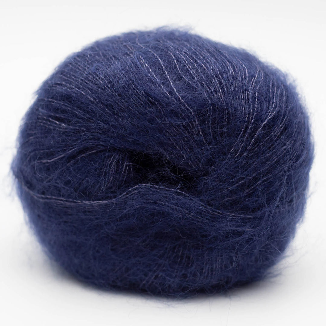Navy blue skein of Silky Kid yarn on a white background