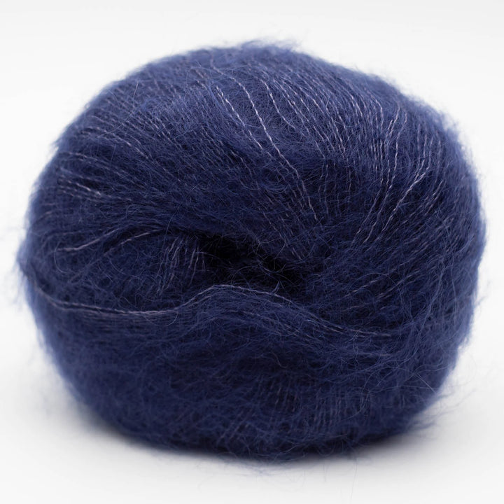 Navy blue skein of Silky Kid yarn on a white background