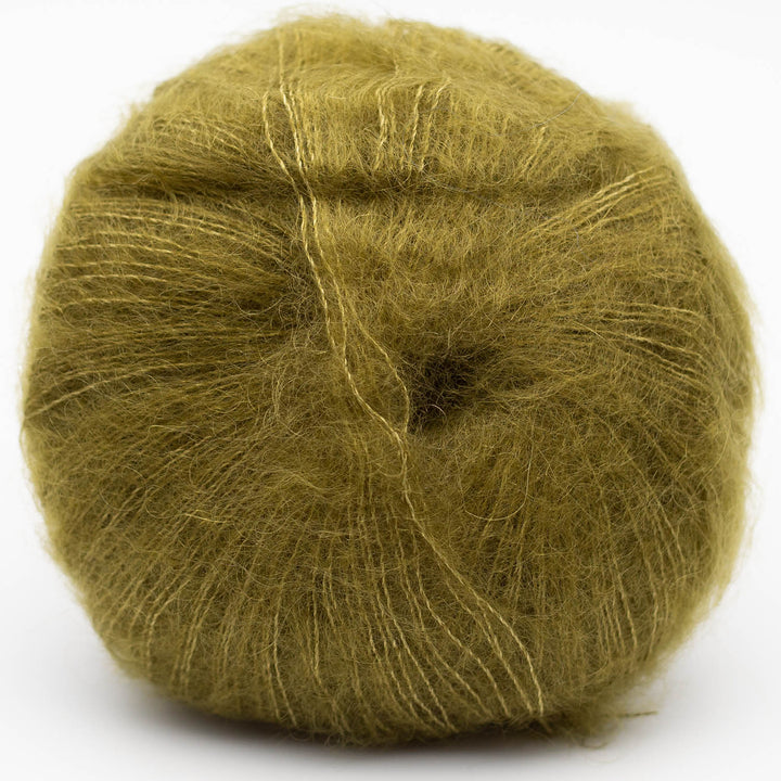 Ball of green Silky Kid yarn in shade olive on a white background
