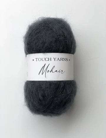 Dark gray skein of yarn with a 'Touch Yarns Mohair' label on a white background
