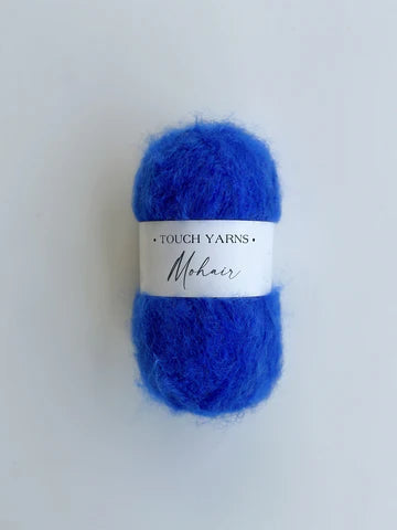 Blue yarn ball with a label on a white background