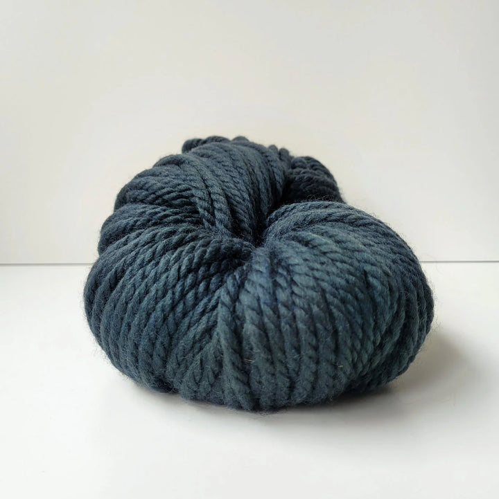 Blue skein of Woolly Yarn Co Super Woolly yarn in the shade nessie on a white background