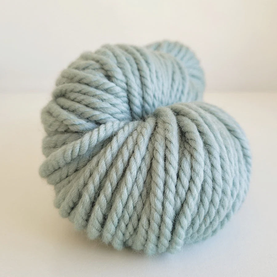 Light blue skein of Woolly Yarn Co Super Woolly yarn on a white background in the shade quackers