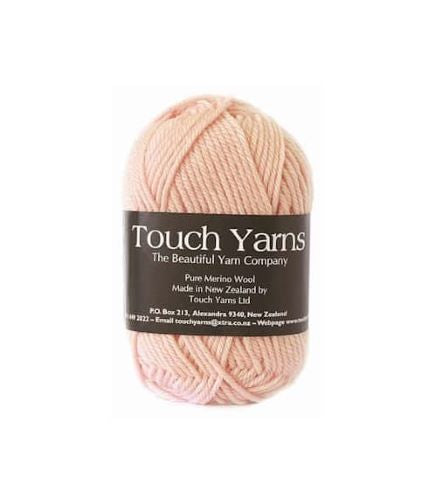 A skein of Touch Yarns Pure Merino 8 Ply wool yarn in the shade peony, with brand label visible.